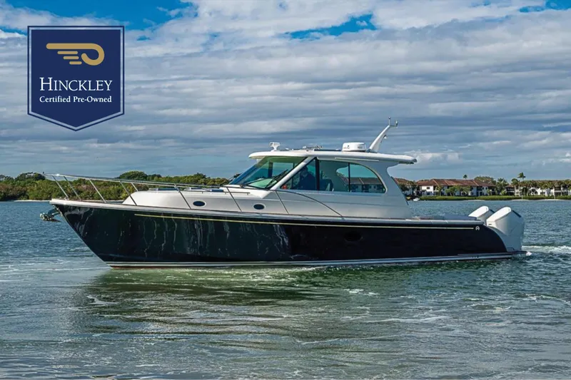 The Image of 2023 Hinckley Sport Boat 40 X cruising on a calm waterway, certified pre-owned. - 0