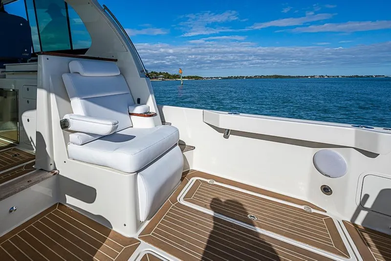 Slide: The Image of Luxury seating on 2023 Hinckley Sport Boat 40 X, overlooking serene ocean view. - 12