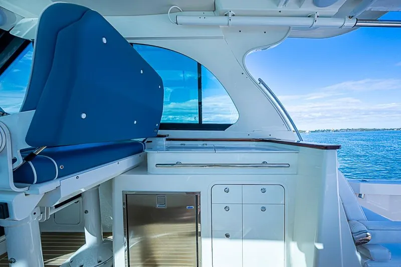 Slide: The Image of 2023 Hinckley Sport Boat 40 X interior with blue seating and ocean view. - 16