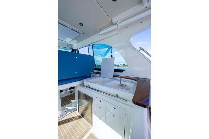 Slide: The Image of 2023 Hinckley Sport Boat 40 X interior with sink and seating area. - 17