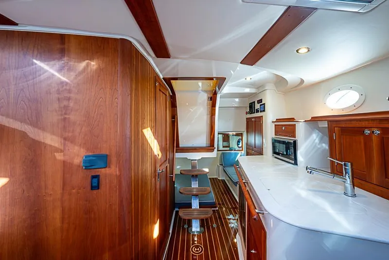 Slide: The Image of Interior of 2023 Hinckley Sport Boat 40 X with elegant wood finishes and modern amenities. - 23