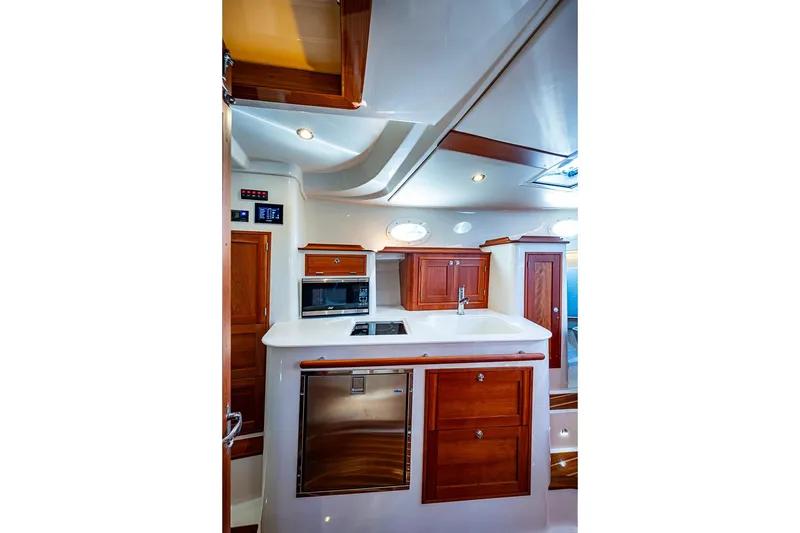 Slide: The Image of Luxurious interior of 2023 Hinckley Sport Boat 40 X with modern kitchen amenities. - 24