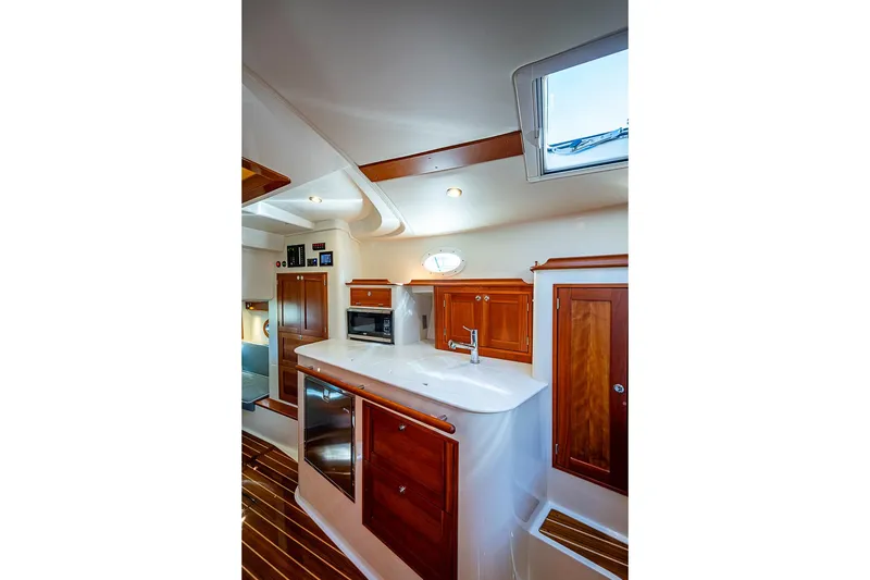 Slide: The Image of Luxurious interior of 2023 Hinckley Sport Boat 40 X with wooden cabinetry and modern amenities. - 25