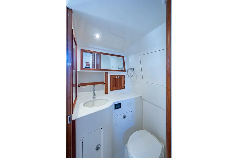 Slide: The Image of 2023 Hinckley Sport Boat 40 X bathroom with modern fixtures and wooden accents. - 29