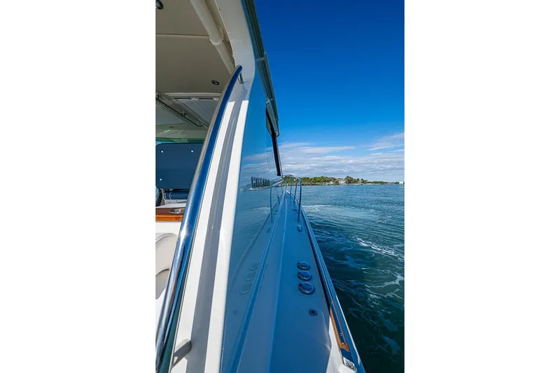 Slide: The Image of 2023 Hinckley Sport Boat 40 X cruising on a sunny day, side view. - 34