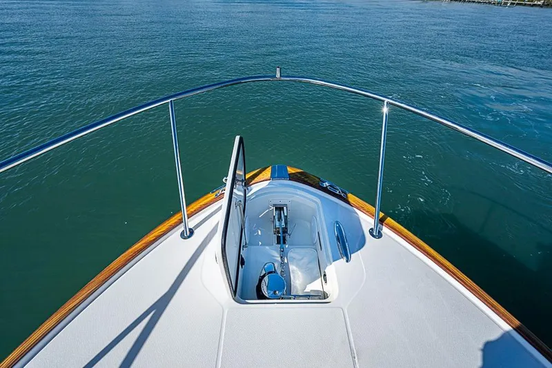 Slide: The Image of 2023 Hinckley Sport Boat 40 X bow view on calm water. - 37
