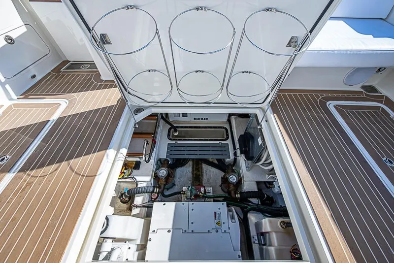 Slide: The Image of 2023 Hinckley Sport Boat 40 X engine compartment with Kohler generator and teak flooring. - 38