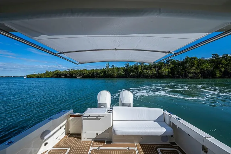 Slide: The Image of 2023 Hinckley Sport Boat 40 X, rear view, cruising on a scenic waterway. - 5