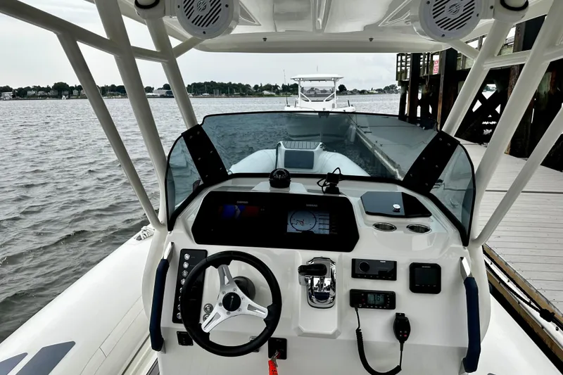 Slide: The Image of 2022 Brig Eagle 8 boat dashboard with steering wheel and navigation controls. - 11