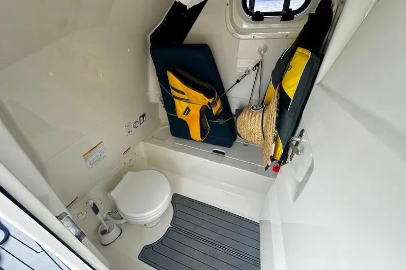 Slide: The Image of 2022 Brig Eagle 8 boat interior with toilet, life jackets, and storage space. - 13