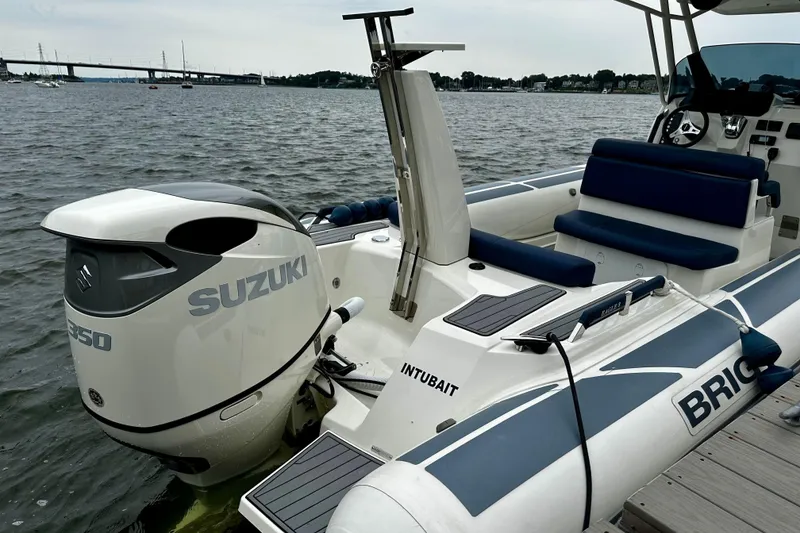 Slide: The Image of 2022 Brig Eagle 8 boat with Suzuki engine docked on a calm waterway. - 15