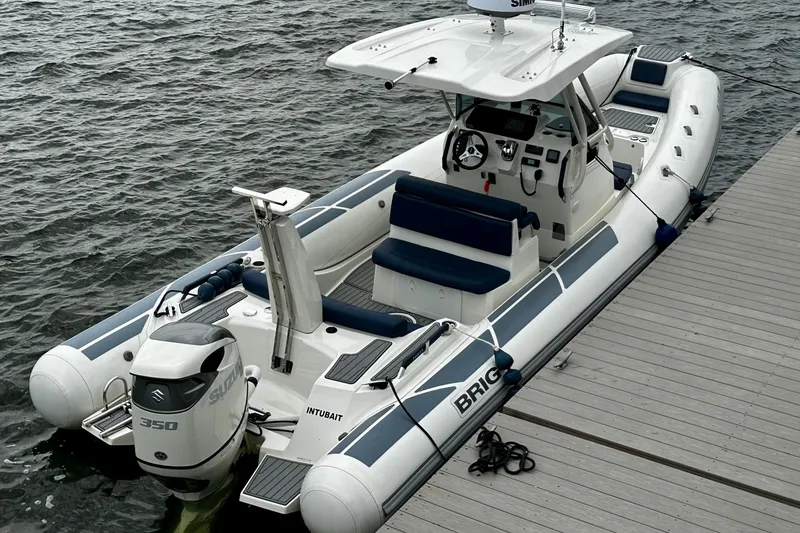 Slide: The Image of 2022 Brig Eagle 8 boat docked, featuring a Suzuki 350 outboard motor. - 3