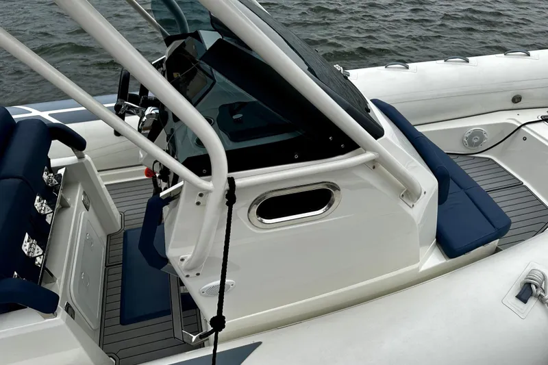 Slide: The Image of 2022 Brig Eagle 8 boat interior with blue seating and sleek design on water. - 8