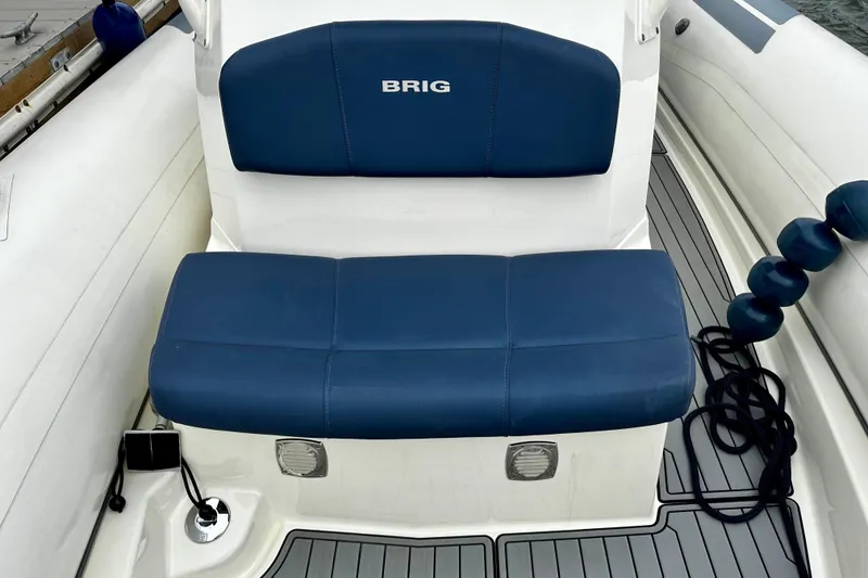 Slide: The Image of 2022 Brig Eagle 8 boat seat with blue upholstery and deck details. - 9