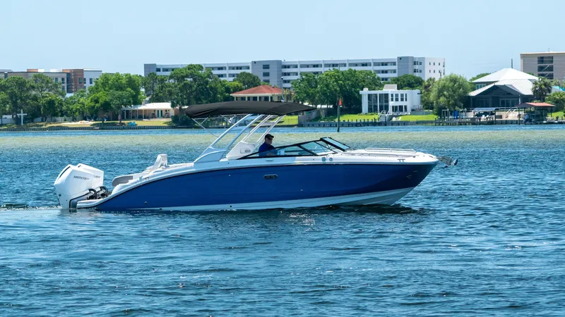 Slide: The Image of 2026 Sea Ray SDX 290 Outboard on water near coastal buildings. - 0