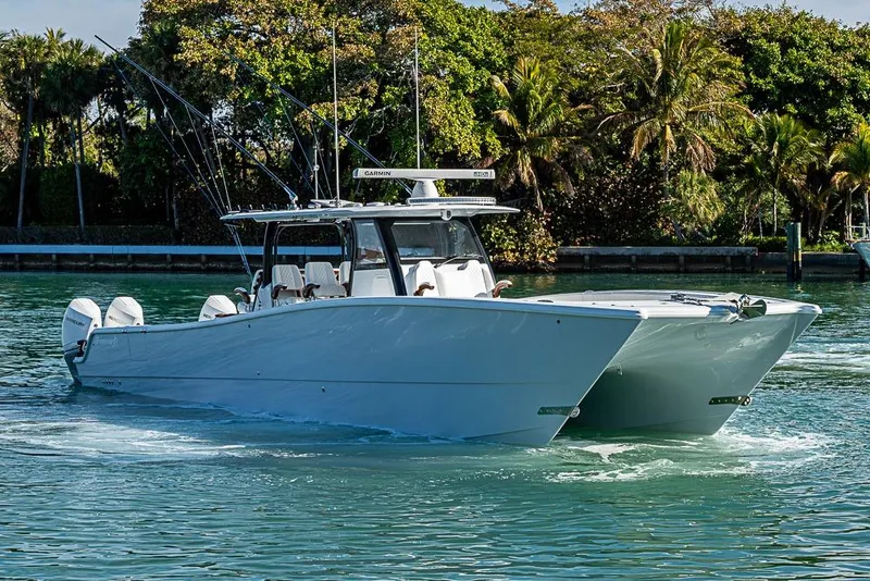 The Image of 2023 Freeman 47 boat cruising on a tropical waterway with lush greenery. - 0