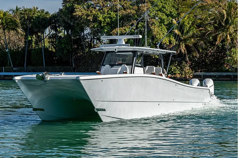 Slide: The Image of 2023 Freeman 47 boat cruising on a scenic waterway with lush greenery. - 20