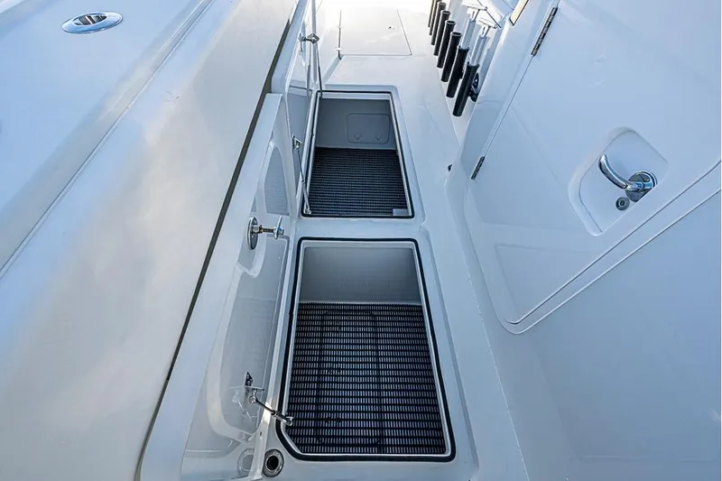 Slide: The Image of 2023 Freeman 47 boat deck with storage compartments and rod holders. - 23