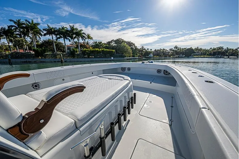 Slide: The Image of 2023 Freeman 47 boat interior with luxurious seating, rod holders, and scenic waterfront view. - 25