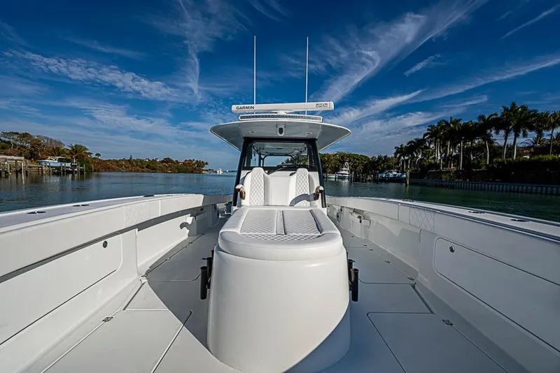 Slide: The Image of 2023 Freeman 47 boat on calm water under a clear blue sky. - 31