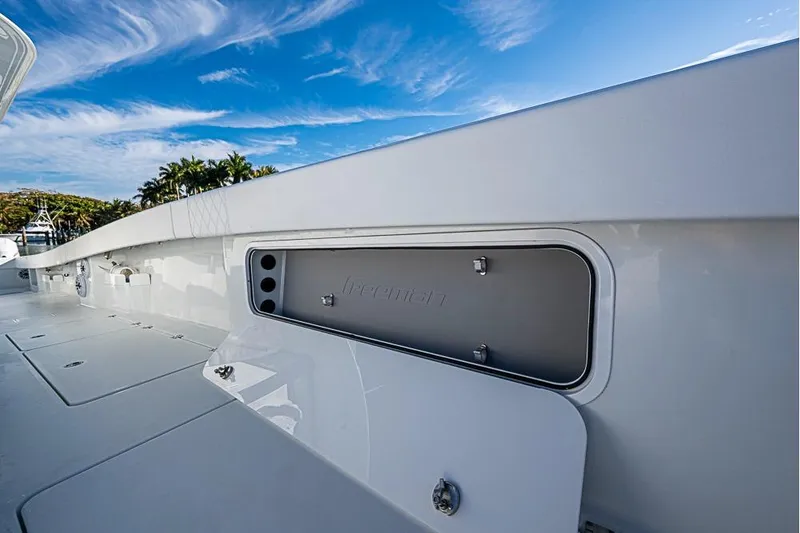 Slide: The Image of 2023 Freeman 47 boat deck with storage compartment under a clear blue sky. - 34