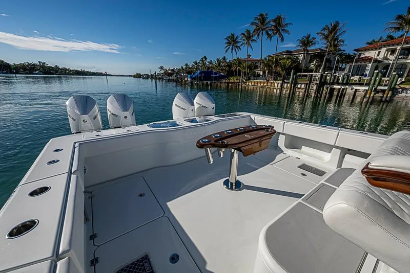 Slide: The Image of Freeman 47 boat, 2023 model, with triple Mercury engines, docked by palm trees. - 38