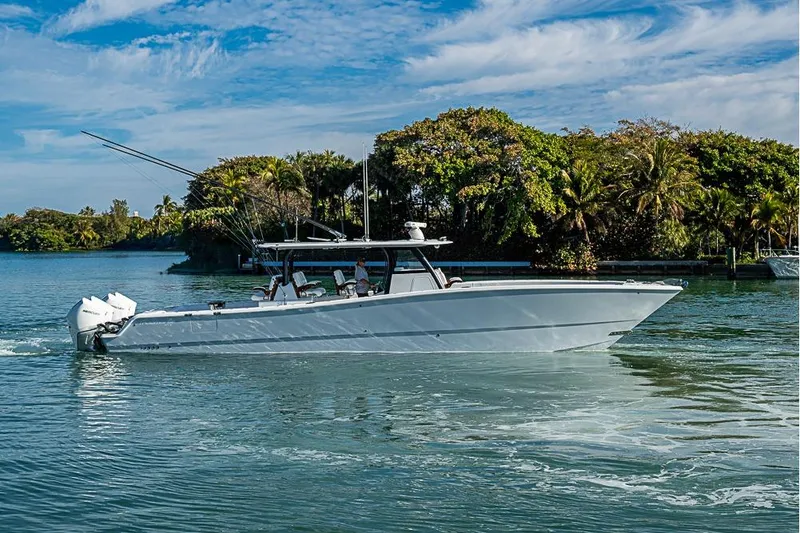 Slide: The Image of 2023 Freeman 47 boat cruising on a scenic waterway with lush greenery. - 4