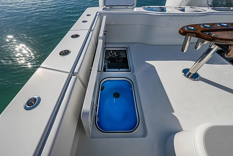 Slide: The Image of 2023 Freeman 47 boat deck with open storage compartments and fishing rod holders. - 42