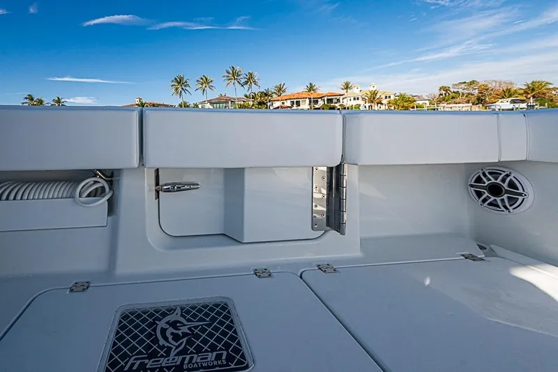 Slide: The Image of 2023 Freeman 47 boat interior with sleek design, palm trees, and blue sky background. - 48