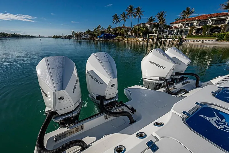 Slide: The Image of 2023 Freeman 47 boat with Mercury engines on a serene waterfront. - 52