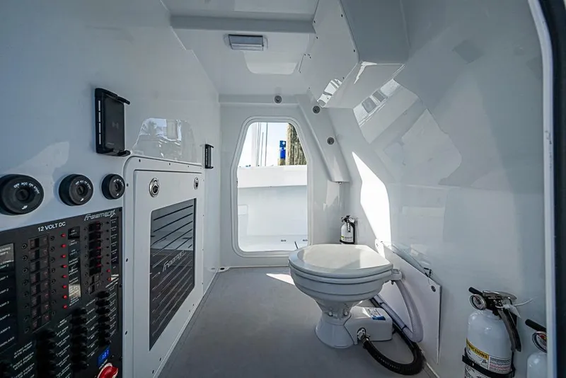 Slide: The Image of Interior of 2023 Freeman 47 boat featuring a compact bathroom with control panel. - 53