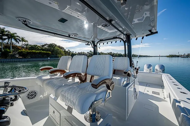 Slide: The Image of Luxurious 2023 Freeman 47 boat interior with plush seating and scenic waterfront view. - 58