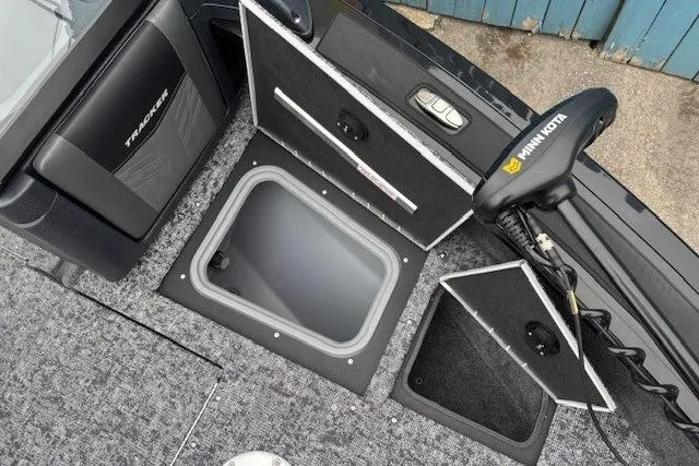 Slide: The Image of 2026 Tracker Targa V-19 Combo boat interior with storage compartments and Minn Kota trolling motor. - 10
