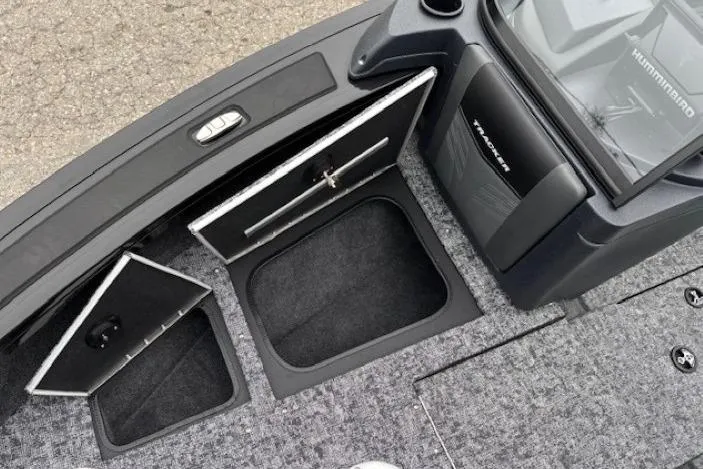 Slide: The Image of 2026 Tracker Targa V-19 Combo boat interior with open storage compartments. - 11