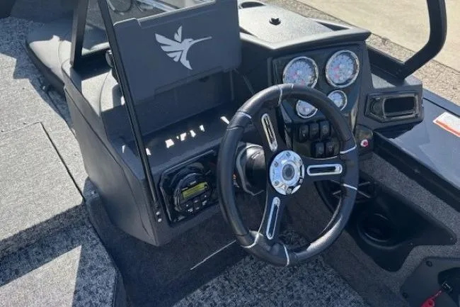 Slide: The Image of 2026 Tracker Targa V-19 Combo boat dashboard with steering wheel and instrument panel. - 16