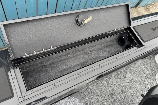 Slide: The Image of 2026 Tracker Targa V-19 Combo boat storage compartment with lock and cup holder. - 20