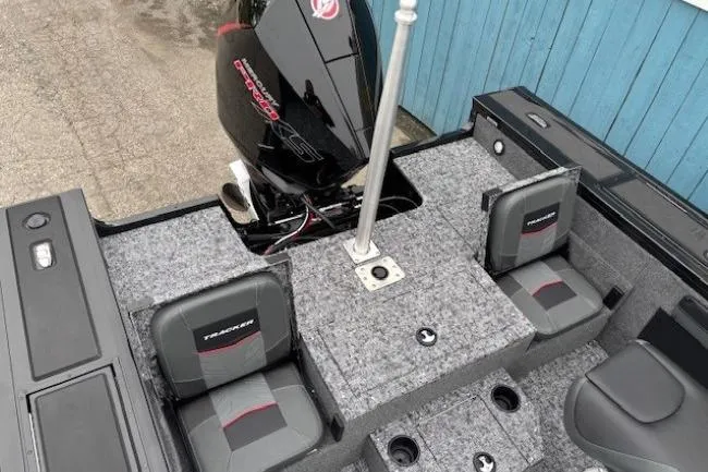 Slide: The Image of 2026 Tracker Targa V-19 Combo boat interior with seating and motor, featuring a modern design. - 25