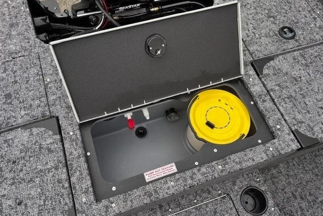 Slide: The Image of 2026 Tracker Targa V-19 Combo boat storage compartment with yellow container. - 27