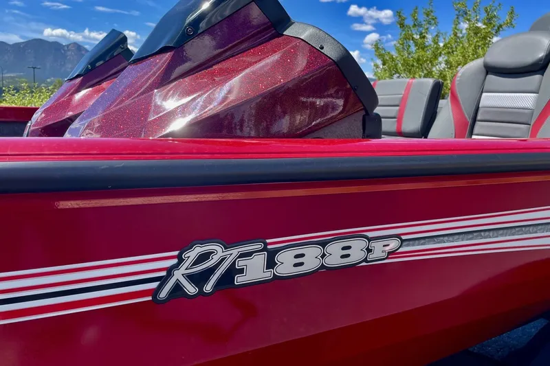 Slide: The Image of 2026 Ranger RT188P boat, red exterior with sleek design and logo, under blue sky. - 6