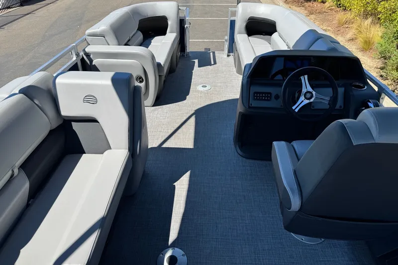 Slide: The Image of Interior view of 2026 Sun Tracker SportFish 22 DLX pontoon boat with seating and steering console. - 8