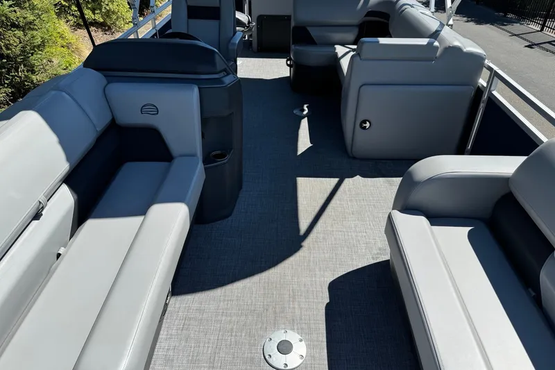 Slide: The Image of 2026 Sun Tracker SportFish 22 DLX pontoon boat interior with gray seating and spacious layout. - 11