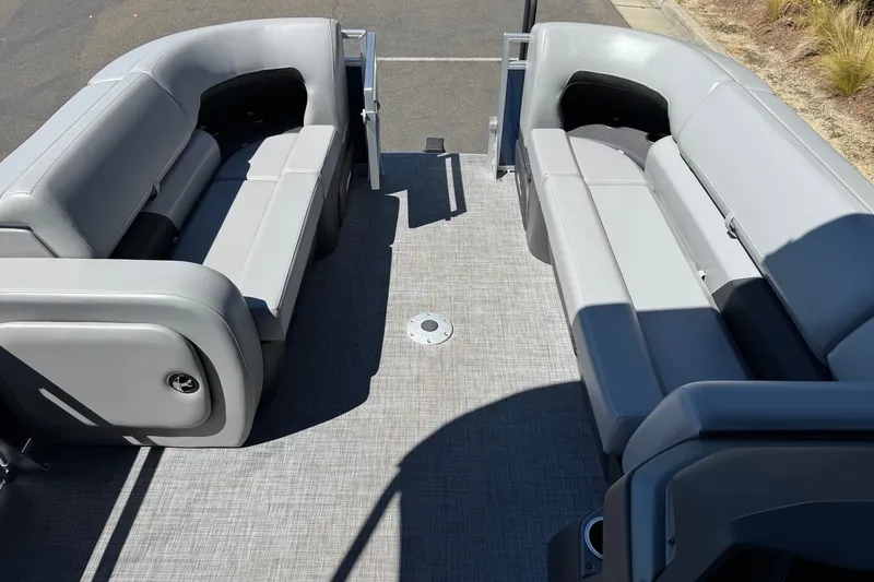 Slide: The Image of 2026 Sun Tracker SportFish 22 DLX interior with gray seating and spacious layout. - 10