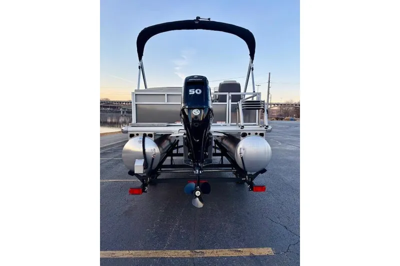 Slide: The Image of 2026 Sun Tracker Bass Buggy 16 XL Select pontoon boat with 50 HP motor, rear view. - 109