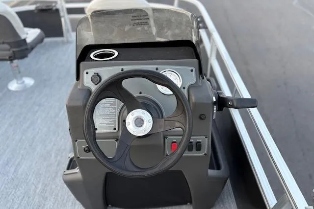 Slide: The Image of 2026 Sun Tracker Bass Buggy 16 XL Select steering console with gauges and controls. - 116