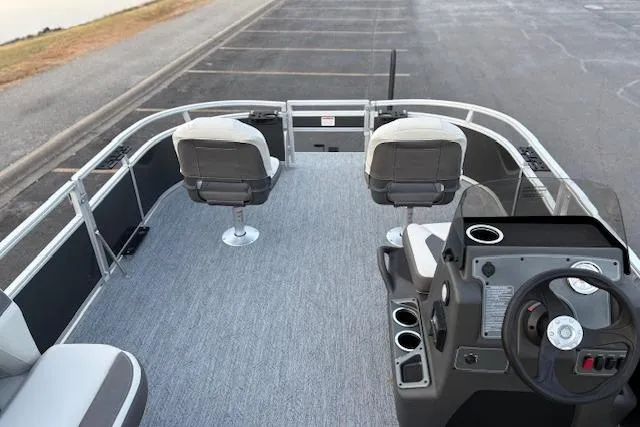 Slide: The Image of 2026 Sun Tracker Bass Buggy 16 XL Select pontoon boat interior with seating and steering console. - 117