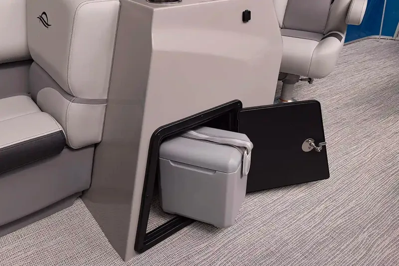 Slide: The Image of 2025 SunCatcher Select 324SL boat interior with storage compartment and cooler. - 9