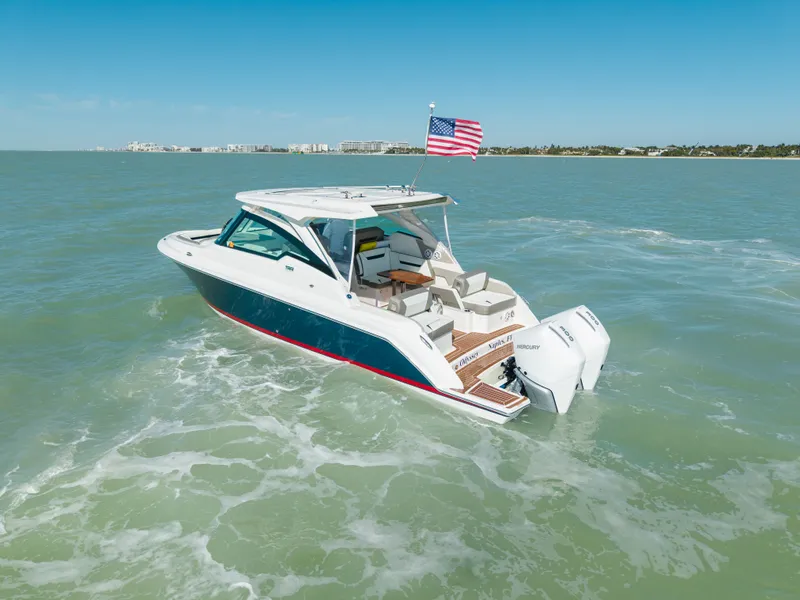 Slide: The Image of 2023 Tiara Yachts 34 LX on open sea with American flag. - 10