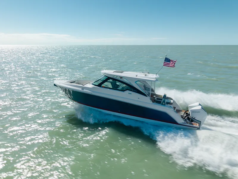 Slide: The Image of 2023 Tiara Yachts 34 LX cruising on open sea under sunny skies. - 13