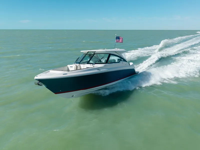 Slide: The Image of 2023 Tiara Yachts 34 LX cruising on open water. - 14
