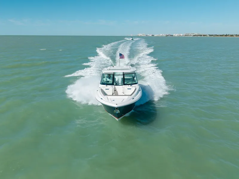 Slide: The Image of 2023 Tiara Yachts 34 LX cruising on open sea. - 15